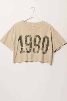 1990 Cropped Vintage-Print Graphic Tee | ShopPromesa Retro Cropped T-shirt With Text Print For Summer, Vintage Slogan Tops For Spring, Vintage Text Print T-shirt For Spring, Acid Wash Cropped T-shirt For Spring, Acid Wash Casual Cropped T-shirt For Spring, Casual Acid Wash Cropped T-shirt For Spring, 90s Style Cropped T-shirt For Spring, 90s Cropped Crew Neck T-shirt For Summer, 90s Style Summer Cropped T-shirt With Crew Neck