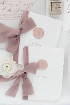 the wedding stationery is laid out on top of each other