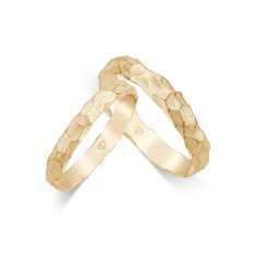 two gold wedding bands with hearts on each band, set in 18k yellow gold