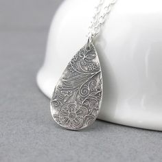 A bohemian style handmade Sterling Silver teardrop, textured with my Enchanted Garden pattern, is one inch in length and suspended from a delicate 1.9mm Sterling Silver cable chain.  The teardrop has been antiqued to a dark black, buffed and tumbled polished and the chain is shiny silver.  Please note that the texture on each teardrop will vary slightly as each one is created one at a time by my own two hands.Sterling Silver Teardrop:  1 inch Chain Length: Please choose at checkout.Matching earr Simple Silver Necklace, Necklace Minimalist Jewelry, Silver Necklace Simple, Silver Charm Necklace, Silver Necklace Pendant, Garden Pattern, Charm Necklace Silver, Necklace Minimalist, Handmade Jewelry Gift