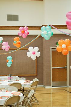 balloons and streamers fill the air over tables