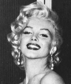 marilyn monroe is smiling and posing for the camera