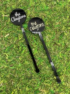 two black and white personalized golf club heads laying on the grass, with the caption'the coupons'written on them