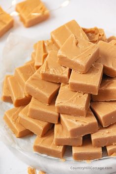 a pile of peanut butter fudges sitting on top of a glass plate