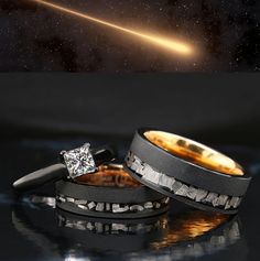 two wedding bands with an image of a star in the background and a diamond ring on top