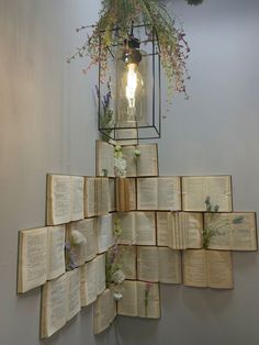 several open books are stacked on top of each other in front of a light fixture