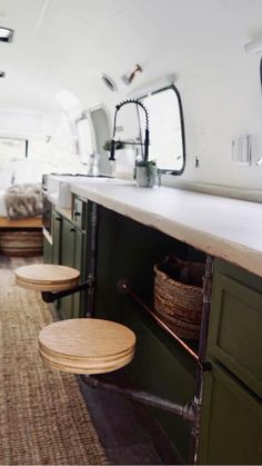 the inside of a camper with two stools