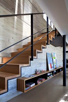 the stairs in this modern house are made of wood and steel, with metal handrails