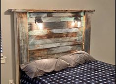 the headboard is made out of wood and has two lights on it