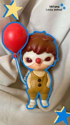 a small plastic toy with a balloon attached to it's head, sitting on a white sheet