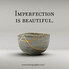 a gray bowl with yellow lines on it and the words imperfectection is beautiful