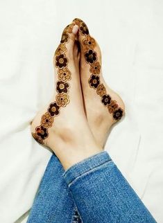 a woman's feet covered in hendi tattoos