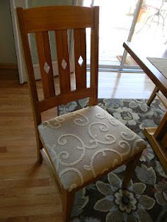 a wooden chair sitting next to a table on top of a hard wood floor