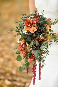 a bridal holding a bouquet of flowers and greenery