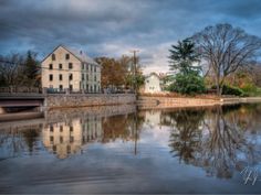 an old house is reflected in the water