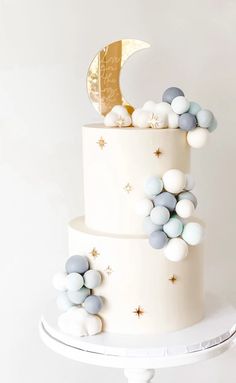 a three tiered cake with white and blue decorations