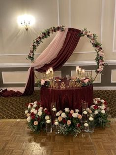 the table is set up with flowers and candles for an elegant wedding reception at the grand ballroom