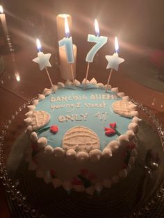 a birthday cake with candles on it sitting on a table