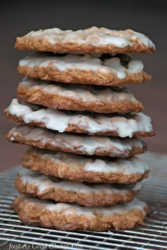 a stack of cookies sitting on top of a metal cooling rack covered in frosting