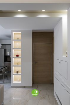 an empty room with white walls and open shelving units on the wall next to it