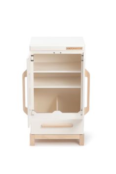 a white wooden toy cabinet with shelves and drawers on the front, open door to reveal an empty drawer