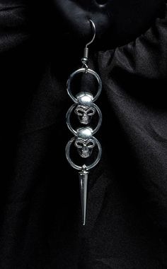 Terrify the competition with these Hanging Skulls Earrings. Lightweight and evil-looking, they'll give any outfit an edgy spike. Made of lightweight materials, these skull earrings make a statement without weighing down your ears. Measurements: 1cm x 6cm.