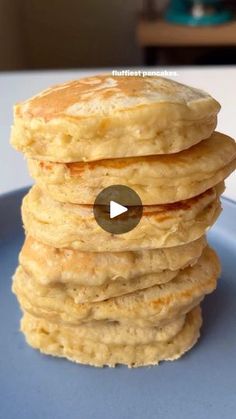 a stack of pancakes sitting on top of a blue plate