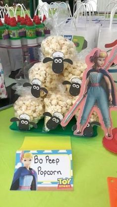 a table topped with lots of popcorn covered in cartoon character figurines and decorations