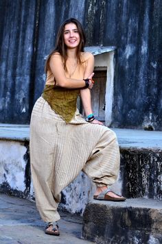 a woman is sitting on the steps posing for a photo with her hand on her hip