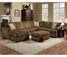 a living room with a sectional couch and ottoman