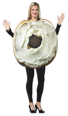 a woman wearing a large bagel costume