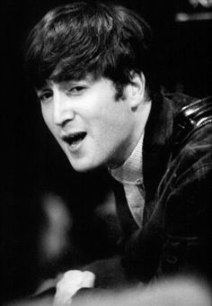 black and white photograph of a young man making a face while sitting at a table