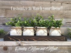 four mason jars with greenery in them on a wooden shelf that says customize to match your decor