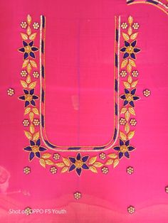 an embroidered pink cloth with gold and blue details