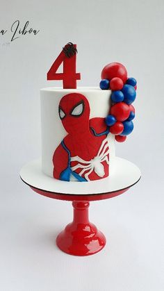 a spiderman birthday cake with balloons on the top and number four on the side