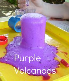 purple volcanos in a yellow tray with two children's hands and one child holding a pipe