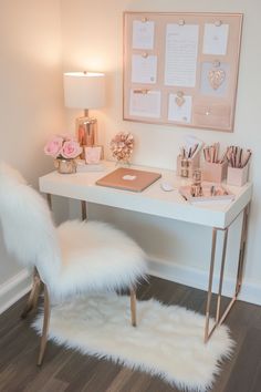 a desk with a chair, lamp and pictures on the wall above it in a home office