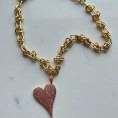 This charming Carrie Love Knot Heart Necklace in gold and pink is perfect for adding a little love to your everyday outfit. With its unique knot design, this necklace is a subtle way to express your affection. Wear it solo or layer it with other pieces for a stylish look. Shop more Necklaces Available in more colors Gold/Pink Barb Wire Chain Slanted pave crystal heart charm 16" around Pink Heart Pendant Jewelry With Adjustable Chain, Pink Heart Shaped Necklace With Adjustable Chain, Valentine's Day Pink Heart Necklace With Adjustable Chain, Pink Heart Pendant Necklace With Heart Charm, Pink Heart Necklace With Adjustable Chain, Pink Open Heart Necklace Gift, Valentine's Day Gold-plated Gold Chain Necklaces, Valentine's Day Gold-plated Gold Chain Necklace, Valentine's Day Gold Plated Gold Chain Necklace