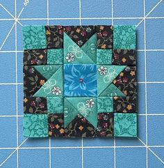 the block is made up of different colors and shapes, including one blue star with flowers on it