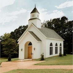 a small white church with a brown door