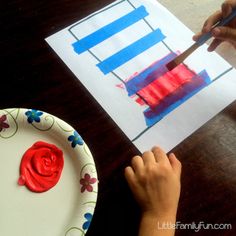 a child is painting on a piece of paper