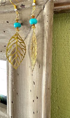 These earrings are a beautiful blend of nature-inspired elegance and boho charm. Featuring a delicate gold-toned leaf pendant paired with a striking turquoise bead, these earrings capture the essence of earthy sophistication. Perfect for adding a touch of nature to any outfit, they are lightweight, versatile, and sure to make a statement. Bohemian Gold Leaf Jewelry, Bohemian Leaf-shaped Pierced Earrings, Bohemian Gold Leaf-shaped Jewelry, Gold Bohemian Leaf-shaped Jewelry, Nature-inspired Turquoise Dangle Earrings, Leaf Pendant, Etsy Earrings Dangle, Turquoise Beads, Essence