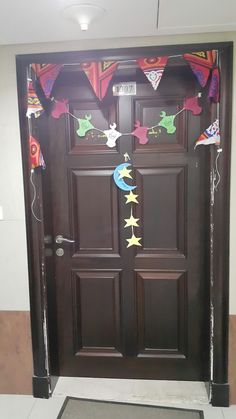 the front door is decorated with decorations and streamers for an upcoming baby's arrival