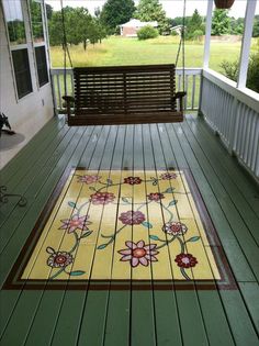 a porch with a bench and rug on the floor next to an open door that says beautiful painted porch rug see more