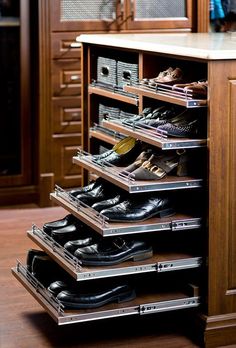 an organized shoe rack in the corner of a closet