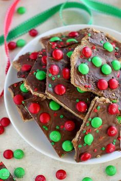 a white plate topped with pieces of chocolate fudges and m & m candy