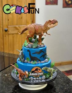 a dinosaur themed cake on top of a table