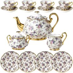 the tea set is decorated with flowers and gold trimmings, along with six matching saucers