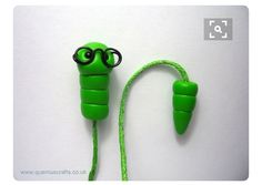 a pair of green ear buds with glasses on them