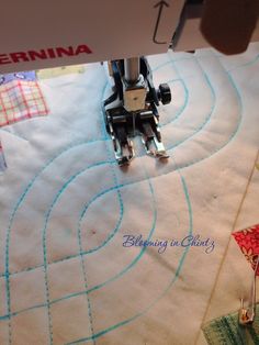 the sewing machine is working on the quilt